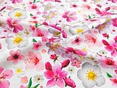 a white and pink flowered fabric with lots of small flowers on it's side