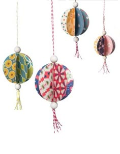 four colorful paper lanterns hanging from strings