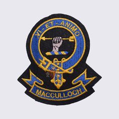 an embroidered patch with the words, navy and anchor in gold on black backings