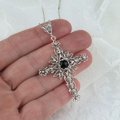 925 Sterling Silver Filigree Art Black Onyx Gemstone Cross Pendant Necklace Silver Chain length is 18.00" + 2.00" extender. Pendant height: 2.30" Pendant width: 1.50" Black Onyx Gemstone is 6 mm, cabochon round cut. Filigree is made of delicate metal strands that have been skillfully fashioned to create an outstanding combination of old and modern art. Originating in Mesopotamia, Anatolia. It is made of delicate metal strands that have been skillfully fashioned to create an outstanding combinati Black Gemstone Necklace For Wedding, Black Engraved Pendant Jewelry, Black Engraved Sterling Silver Jewelry, Bohemian Crucifix Necklace As A Gift, Bohemian Crucifix Necklace As Gift, Elegant Black Jewelry With Intricate Design, Bohemian Crucifix Necklace, Elegant Black Necklaces With Oxidized Finish, Elegant Black Necklace With Oxidized Finish