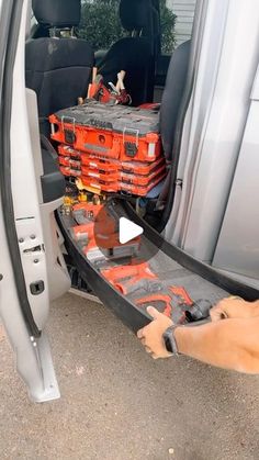 an orange crate is in the back of a van with it's door open