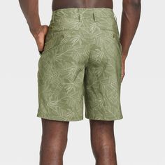 Move from the land to the sea in botanical style with these Leaf Print Hybrid Swim Shorts from Goodfellow & Co™. These hybrid swim shorts made from 4-way stretch, wrinkle-resistant fabric offer comfortable wear in or out of water. A fly button and zipper along with belt loops offers a secure fit, while the side and back pockets come in handy for stashing small essentials. Plus, the UPF 50+ rated material helps keep you protected from the sun. Pair them with your regular tees and sneakers for a c Hawaiian Style Bottoms With Built-in Shorts For Vacation, Vacation Hawaiian Style Shorts, Outdoor Vacation Shorts, Vacation Outdoor Shorts, Green Hawaiian Summer Bottoms, Casual Vacation Shorts For Outdoor, Green Hawaiian Style Short Bottoms, Green Tropical Swim Trunks With Built-in Shorts, Tropical Bottoms With Built-in Shorts