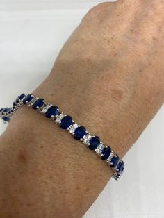 Vintage Blue Crystal Cubic Zirconia Bracelet Sterling Silver Tennis Classic Blue Cubic Zirconia Tennis Bracelet, Classic Blue Bracelet Jewelry, Classic Sapphire-colored Cubic Zirconia Bracelets, Classic Blue Sterling Silver Bracelets, Classic Blue Cubic Zirconia Jewelry, Sapphire Bracelets As A Gift, Classic Blue Bracelets, Classic Blue Jubilee Bracelet, Blue Cubic Zirconia Tennis Bracelet Fine Jewelry