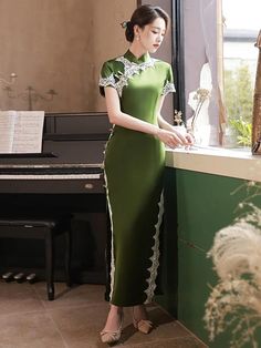 Fall in love with a long green qipao dress and its classy design. Made in a vibrant green color, this Chinese dress looks both elegant and refreshing. The satin fabric, carefully selected for its softness and comfort, adds a touch of sophistication to the long qipao dress. Green Short Sleeve Evening Dress For Banquet, Green Short Sleeve Evening Dress For Wedding, Elegant Light Green Maxi Dress, Fitted Dark Green Floor-length Dress, Dark Green Fitted Floor-length Dress, Green Long Dress For Banquet, Elegant Dark Green Floor-length Maxi Dress, Elegant Dark Green Dress For Banquet, Elegant Dark Green Banquet Dress