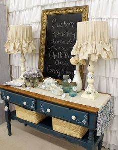 a table with two lamps and a chalkboard on it