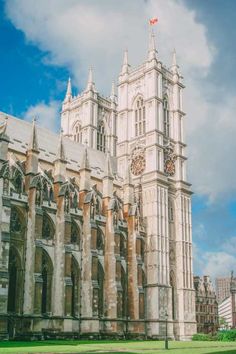 an old building with a clock on the front and side of it's tower