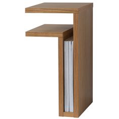 a wooden table with a magazine rack on it's side and an open book in the middle