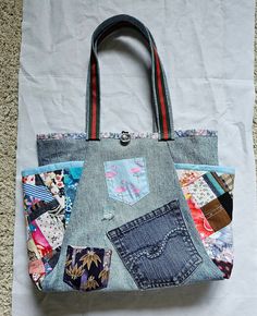 a handbag made out of old jeans with patchwork and patches on the side