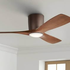 a ceiling fan in a room with white walls