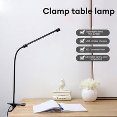 a lamp that is on top of a table next to a book and some books