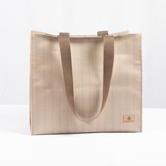 One of our most popular products, this shopper is perfect for almost anywhere you can imagine. This fabric is as robust as it gets. The bag is handcrafted from the excess material reclaimed from a high-end outdoor furniture company. Our customers love it for:- a work tote- a beach bag- a market tote- a mom bag (all the snacks and toys!)- a project bag- a library bag You can't go wrong! The bag features durable double straps that are the perfect length to tuck this bag right under your armBoth sturdy and elegant, this bag can be wiped down with a damp rag, hand sanitizer, or a disinfecting wipe. Take it to the gym, the beach, the store, and more. We're betting this is about to be your new favorite bag too. Details: 100% upcycled patio furniture fabric Dimensions: 18" x 6" x 12.5" Straps: Tw Large Eco-friendly Shoulder Bag For Everyday, Eco-friendly Double Handle Canvas Shopping Bag, Eco-friendly Double Handle Shopping Canvas Bag, Large Eco-friendly Bag For Everyday Use, Large Eco-friendly Everyday Bag, Eco-friendly Tote Shoulder Bag For On-the-go, Eco-friendly Tote Bag With Top Carry Handle, Eco-friendly Canvas Bag With Removable Pouch For Everyday Use, Natural Large Capacity Bag For Everyday Use