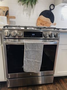 an oven with a towel hanging on it