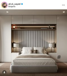 a large bed sitting in the middle of a bedroom next to a wall mounted shelf