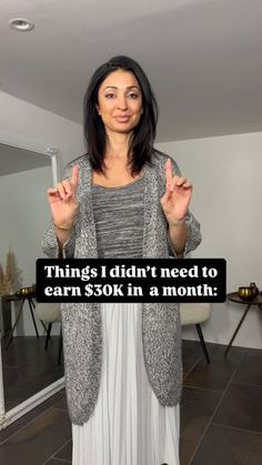 a woman standing in front of a mirror holding her hands up and saying, things i didn't need to earn $ 50k in a month