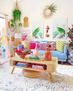 a living room filled with lots of colorful furniture and art on the wall above it