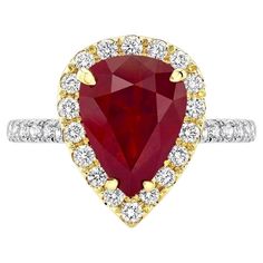 18K white and yellow gold ring, featuring a dazzling 3.82-carat, pear-shaped Burmese Ruby, surrounded by 30 round white diamonds weighing 0.58 carats. This rare Ruby is GIA certified. Gia Certified Pear Diamond Ring, Gia Certified Pear-shaped Diamond Ring, Teardrop Ruby Ring With Diamond In Fine Jewelry Style, Teardrop Ruby Ring In Fine Jewelry Style, Fine Jewelry Teardrop Ruby Ring With Diamond, Gia Certified Teardrop Diamond Ring, Diamond Ruby Ring With Prong Setting In Pear Shape, Gia Certified Teardrop Diamond Ring Fine Jewelry, Gia Certified Teardrop Diamond Ring In Fine Jewelry Style