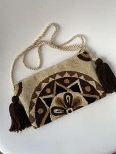 This is a handmade crochet pouch made by the Wayuu tribe from Colombia. Is one thread weaven, made with ancestral wisdom and special meaning. It looks so hippie chic and everyone will talk about it 100% COTTON directly from the Wayu' community in Guajira  Colombia, with your purchase, we help the Wayuu people to its development and evolution. Approximate dimensions: H: 5.5inch x W: 10.5inch. Straps approx. 22 Inches long Festival Handwoven Crochet Pouch Bag, Woven Crochet Pouch Bag For Festivals, Bohemian Crochet Pouch Bag For Daily Use, Festival Woven Crochet Pouch Bag, Bohemian Brown Crochet Bag With Woven Details, Bohemian Brown Crochet Shoulder Bag, Bohemian Brown Woven Crochet Bag, Bohemian Brown Crochet Bag With Weaving, Bohemian Woven Crochet Pouch Bag