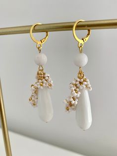 Introducing my exquisite Beaded White Jade teardrop earrings, perfect for adding a touch of elegance to any occasion. Round White Jade bead and mini beaded flowers is delicately placed to create a mesmerizing design and looks super cute. The 10x30mm natural White stone teardrop adds an extra dimension to these earrings, making them a unique and glamorous accessory. With a total lenght of 7 cm including the latch back closure, these earrings are the perfect size to make a statement without being White Beaded Drop Jewelry, Elegant Beaded Teardrop Drop Earrings, White Beaded Teardrop Earrings, Elegant Dangle Earrings With Faceted Beads, Elegant Flower Earrings With Dangling Beads For Gift, Handmade Elegant Long Drop Beaded Earrings, Elegant Drop Crystal Earrings With Faceted Beads, Elegant Handmade Long Drop Beaded Earrings, Elegant Wedding Earrings With Gemstone Beads