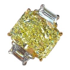 This fancy yellow radiant cut diamond is offered by Antinori di Sanpietro ROMA. This 4ct fancy light yellow radiant diamond is custom set in a handcrafted Antinori di Sanpietro ROMA platinum and 18 karat yellow gold. 3 stone ring consisting of 1 radiant cut fancy yellow diamond weighing 4.02 carats with VVS2 clarity accompanied by GIA report, accented by 2 side diamonds with a total weight of approximately 1 carat, and a respective color and clarity of E-F VS1-VS2 quality. Fine Jewelry Yellow Three Stone Rings, Yellow Diamond Ring With Cushion Cut, Dazzling Brilliant Cut Yellow Diamond Ring, Dazzling Yellow Brilliant Cut Diamond Ring, Luxury Three Stone Diamond Yellow Jewelry, Luxury Three Stone Yellow Diamond Jewelry, Yellow Radiant Cut Diamond Ring With Prong Setting, Yellow Diamond Ring With Radiant Cut And Diamond Accents, Yellow Diamond Ring With Radiant Cut And Accents