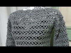 a crocheted top is displayed on a mannequin