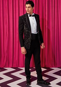 Get ready to make a statement at formal events with our Black Silver Embellished Tuxedo Set. Crafted from luxurious textured suiting, this set features an elegant black blazer embellished with black and silver work. Paired with an exquisite bowtie, sash, pintuck shirt, and pants, this set is perfect for elegant occasions like cocktails or wedding receptions. Elevate your look and impress everyone around you. Components : 5 (Blazer, shirt, bowtie, sash and pants) Composition : Textured Suiting Care: Dry Clean Only and Vacuum Storage This product can be customized for sleeves, length of blouse and neckline Delivery : 4-6 weeks as the product is hand crafted. Check Size Guide or choose MySize for free customisation (All Sizes above XL can be made at 15% additional cost) For more information a Pintuck Shirt, Mens Formalwear, Vacuum Storage, Indian Wedding Wear, Blazer Shirt, Silver Work, Wedding Receptions, Black Blazer, Shirt And Pants