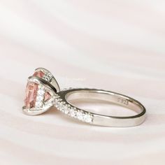 Beautiful Cushion Morganite Ring ►Made of solid sterling silver with rhodium finish (925) ►Accented with simulated diamonds (CZ) ►Average band width: 2.1 mm Center Stone: Morganite Color: Peachy-Pink Shape: Cushion Measurements: 7.0 x 7.0 mm Carat Weight: 2 ct. (approx.) Gemstone creation: Lab-Created ✓ 100% Nickel-Free ✓ Hypoallergenic ✓ Comfort Fit ✓ Free Ring Box ✓ Free USA Shipping ✓ Ready to ship next business day Elegant Sapphire Ring With Side Stones For Wedding, Classic Promise Ring With Side Stones, Classic Promise Rings With Side Stones, Classic Morganite Diamond Ring With Round Cut, Oval Rings With Side Stones For Gift, Silver Oval Rings With Side Stones, Oval Silver Rings With Side Stones, Morganite Round Cut Promise Ring, Morganite Diamond Ring With Center Stone For Wedding