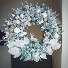 a christmas wreath with blue and white decorations