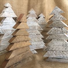 several wooden christmas trees sitting next to each other