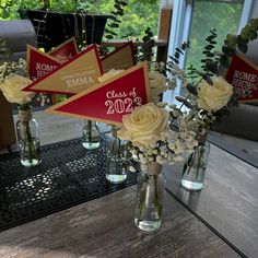 vases filled with flowers on top of a wooden table