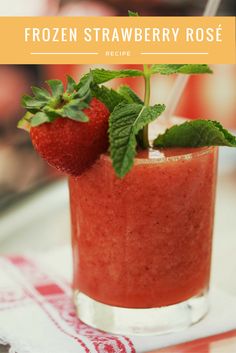 two strawberries sit on top of a smoothie in a glass with a straw