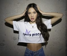 a woman with long dark hair wearing a white t - shirt that says spicy bisce