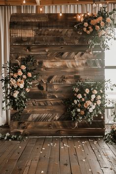 an image of a wooden wall decorated with flowers and greenery for a wedding ceremony