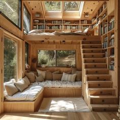 a living room filled with lots of furniture and bookshelves next to a window