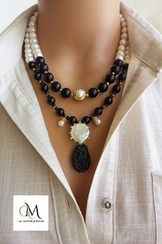 The elegant Onyx and Pearl Beaded Necklace, a true statement accessory that effortlessly combines the beauty of nature with timeless elegance. This stunning piece showcases the stunning black tones of genuine Onyx beads, delicately accented with sparkling freshwater pearls. Each bead has been meticulously selected to provide a harmonious blend of colors and textures, creating a truly unique and eye-catching design. Handmade Statement Necklace, Pearl Beaded Necklace, Delicate Pendant, Black Tones, Unique Anniversary Gifts, Pendant For Women, Jewelry Statement, Necklace Beaded, Onyx Bead