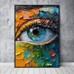 an abstract painting on the wall with a colorful eye painted in bright blue, orange and yellow