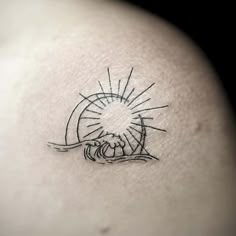 a tattoo on the back of a woman's shoulder