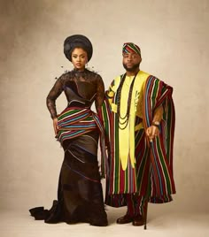 a man and woman dressed in african clothing