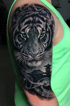 a black and white tiger tattoo on the arm