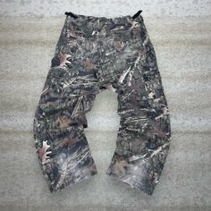 "Vintage Hunting Camo Tactical Pants Baggy Fit Cargos Crazy Woodland Pattern Bear Ridge 90s Skate / Streetwear Great Condition: 7/10 (work wear , aka some character) Men's Size:  Waist: 36\" Length (inseam): 32\" Leg Opening: 9.5\" Thigh Opening: 13\" Front Rise: 12\"" Utility Camouflage Cotton Parachute Pants, Camouflage Cotton Utility Parachute Pants, Utility Baggy Parachute Pants For Outdoor, Baggy Parachute Pants With Multiple Pockets For Outdoor, Baggy Combat Cargo Jeans, Baggy Combat Pants For Outdoor, Outdoor Camouflage Cotton Pants, Baggy Camouflage Utility Parachute Pants, Combat Style Wide Leg Cargo Pants