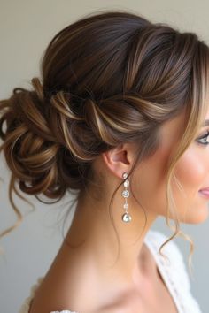 a woman wearing a wedding dress with her hair in a low updo and pearls