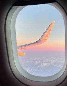 the view from inside an airplane window at sunset