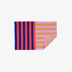 two pieces of pink, orange and blue striped fabric on a white background with one piece folded in half