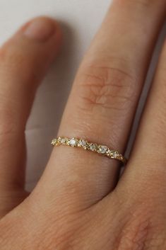 a woman's hand with a diamond ring on it