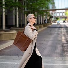 Finally - a show-stopping leather tote that can accommodate your needs (and your hats!) The Natalie's diverse functions keep your hat, blanket, or travel pillow secure and accessible! A large exterior pocket is perfect for your phone or reading material, while the raw leather interior is spacious enough for your weekend getaway supplies or everyday essentials. The bottom two snaps on the leather straps allow for wider-brimmed hats (image shown with 13.5" hat) and the detachable crossbody strap g Classic Brown Travel Accessories For On-the-go, Winter Travel Brown Shoulder Bag, Versatile Winter Travel Bags, Versatile Travel Bags For Winter, Camel Shoulder Bag Large Capacity For Travel, Casual Camel Shoulder Bag For Travel, Versatile Winter Travel Shoulder Bag, Versatile Shoulder Bag For Winter Travel, Modern Camel Shoulder Bag For Travel