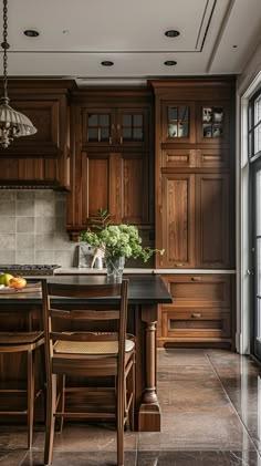 a large kitchen with wooden cabinets and black counter tops, along with a dining room table