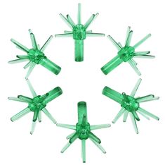 six green plastic objects arranged in a circle