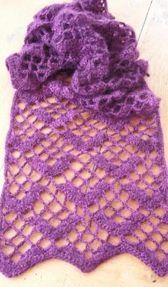 a close up of a purple scarf on a white surface