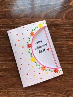 a mother's day card sitting on top of a wooden table