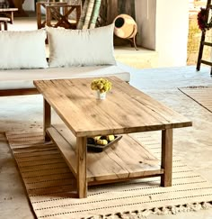 a wooden coffee table sitting on top of a rug