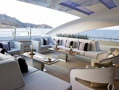 the inside of a boat with couches and tables